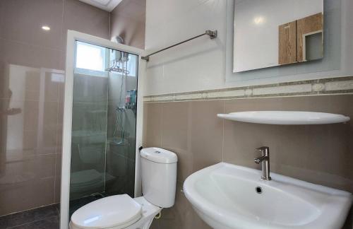 a bathroom with a toilet and a sink and a shower at 98 Tower Chiang Mai in Chiang Mai