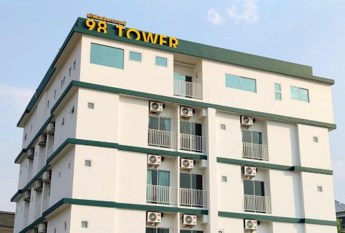 a building with a hotel sign on top of it at 98 Tower Chiang Mai in Chiang Mai