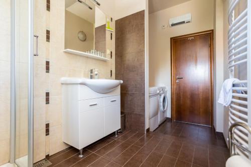 a bathroom with a white sink and a shower at APARTMANI BEBA in Omišalj