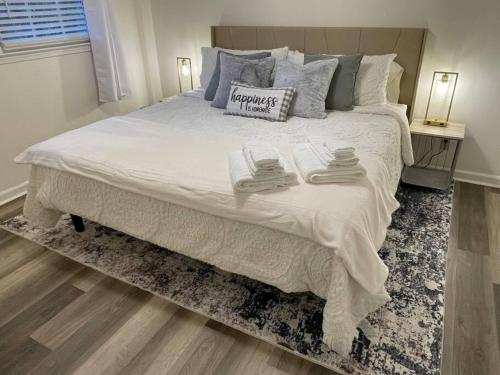 a bedroom with a large bed with two towels on it at NEW King Beds, 86 inch RokuTV, and Massage at the Comfort Haven in Commerce