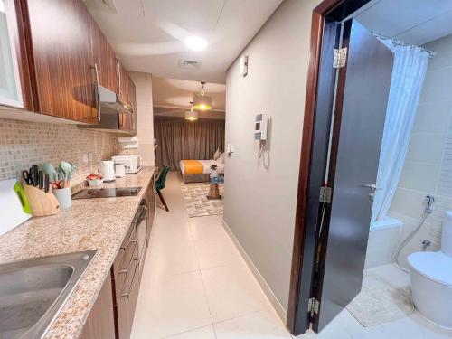 a bathroom with a sink and a toilet in a room at Cosmos Living Stylish Studio Near Marina in Dubai