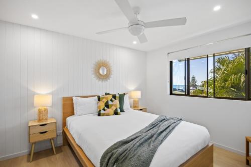 a white bedroom with a bed and a window at Beachside Views 2 Bedroom Apartment Mooloolaba in Mooloolaba