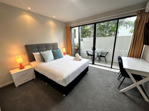 1 dormitorio con cama, escritorio y ventana en Ipanema Holiday Resort en Gold Coast