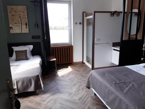 Postel nebo postele na pokoji v ubytování L'Aparté