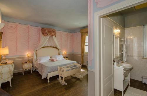 a bedroom with a bed and a sink in it at La Chandelle in Massarosa