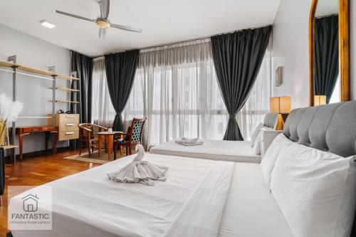 a hotel room with a bed and a desk at Regalia Residence @ KLCC View Sky Pool by MC in Kuala Lumpur