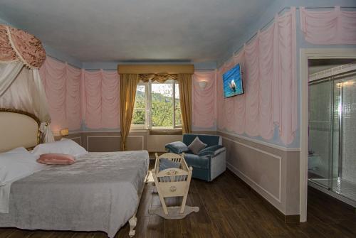 a bedroom with a bed and a chair and a window at La Chandelle in Massarosa