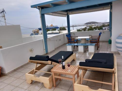 a balcony with a table and chairs on a boat at Katy's Home in Naxos Chora