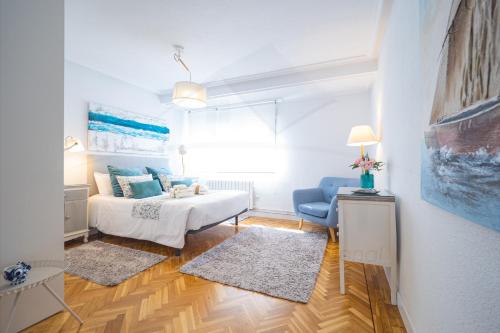 uma sala de estar com uma cama e um sofá em Playa Apartamento Frente al mar em Gijón