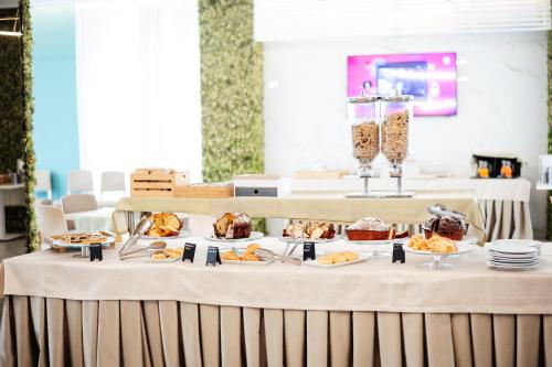 a table with several plates of food on it at Hotel St. Giorgio in Castel San Giorgio