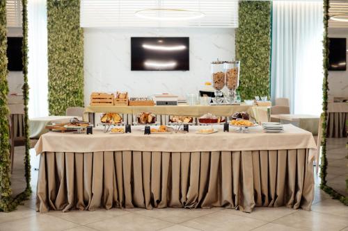 a large table with food on it in a restaurant at Hotel St. Giorgio in Castel San Giorgio