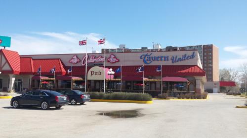 a restaurant with cars parked in a parking lot at Canad Inns Destination Centre Fort Garry in Winnipeg