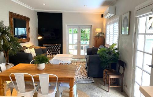 a living room with a table and chairs at The Edward Townhouse 157 - Steps to Town in Orange