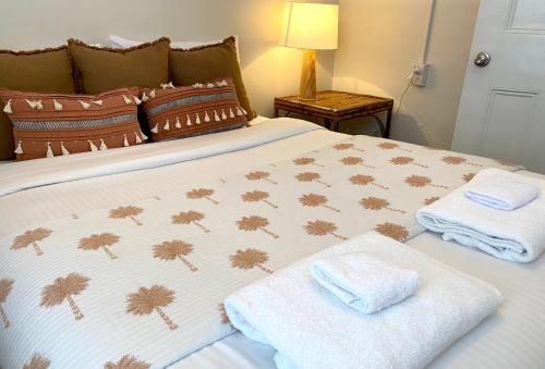 a bedroom with a bed with towels on it at The Edward Townhouse 157 - Steps to Town in Orange