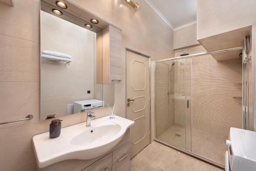 a bathroom with a sink and a shower at Adelais Luxury City Apartment Rhodes in Rhodes Town