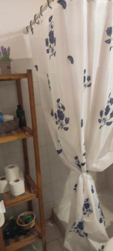 baño con cortina de ducha azul y blanco en Spiti Mitsis, en Arillas
