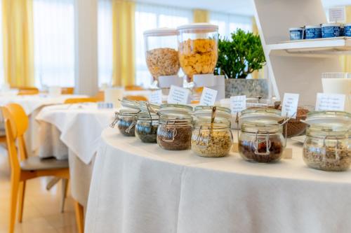 a table with jars of food on top of it at Hotel Doria in Cavi di Lavagna