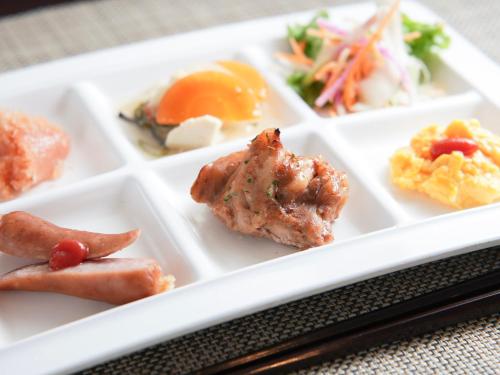 a white plate with different types of food on it at Super Hotel Kokuraeki Minamiguchi in Kitakyushu