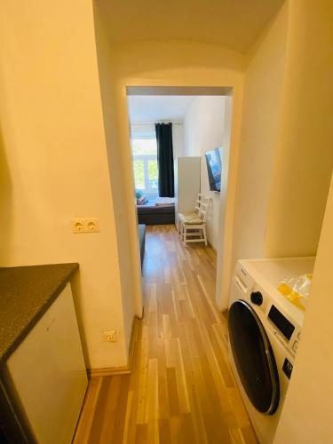a kitchen with a washer and dryer in a room at NiceApartmentHollergasse 1a in Vienna