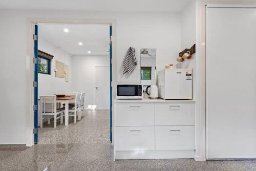 a kitchen with a white refrigerator and a table at Scarborough Beach Break Holidays - Unit 5 in Scarborough