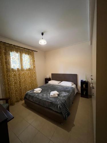 a bedroom with a bed with two towels on it at Sunlight Experience in Artemida