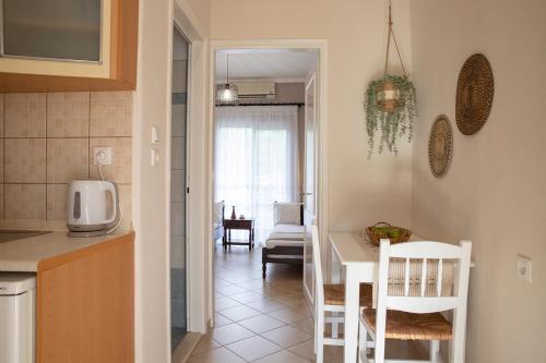 a kitchen and a dining room with a table and chairs at Elena luxury living in Paralía Skotínis
