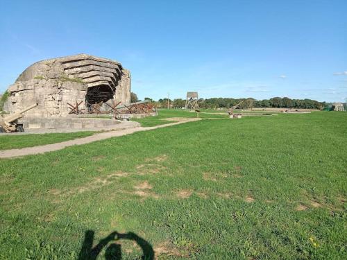 a shadow of a person standing in a field at Poisson in Isigny-sur-Mer