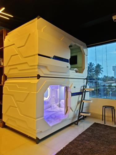 a large yellow and white oven in a room at TRIVPODS Capsule Hotel in Trivandrum