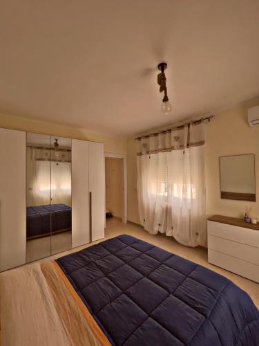 a bedroom with a large bed and a mirror at Casa Loredana in Putignano