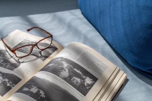 a book with a pair of glasses on top of it at Hotel Doria in Cavi di Lavagna
