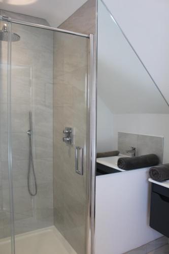 a shower with a glass door in a bathroom at Henley-on-Thames in Henley on Thames