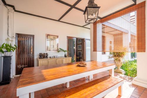a large dining room with a wooden table at Holland House B&B in Durban