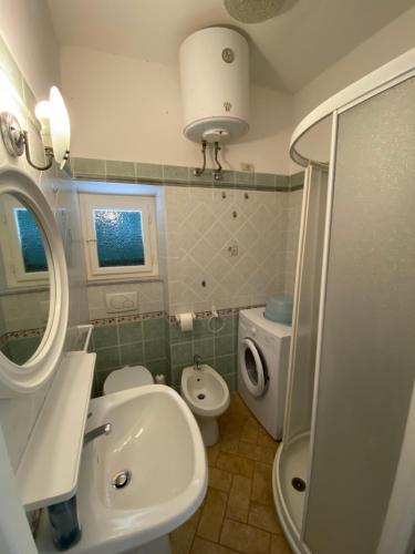 a small bathroom with a sink and a toilet at Luisa Solferino 2 in Porto Azzurro