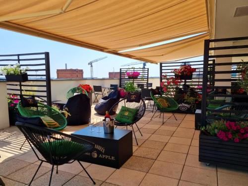 a patio with chairs and a table with flowers at Holiday Inn Łódź by IHG in Łódź