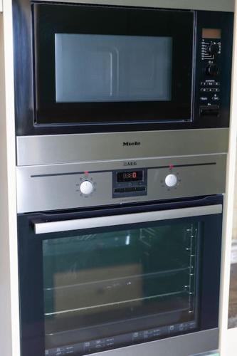 a microwave sitting on top of a oven at Sensia villa with Hot tub and Caldera View in Oia