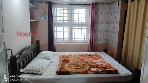 a hospital bed in a room with a window at Sharon Home Stay in Madikeri