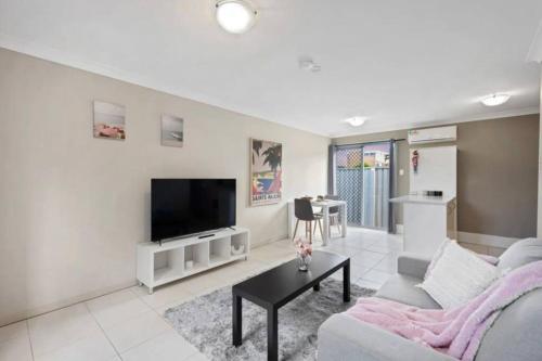 a living room with a couch and a tv at One bedroom holiday rental in Scarborough in Scarborough