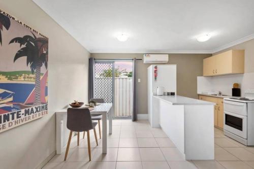 a kitchen with a counter and a table with a chair at One bedroom holiday rental in Scarborough in Scarborough