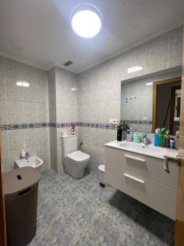 a bathroom with a sink and a toilet and a mirror at Habitación privada in Valencia