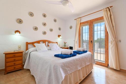 a bedroom with a large bed and a window at Pinecrest in Jávea