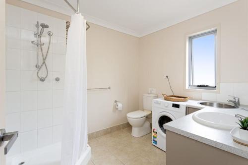 a bathroom with a toilet and a sink and a shower at Self-contained unit in Scarborough in Scarborough