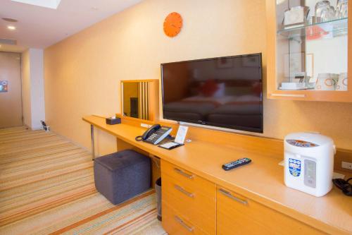 a hospital room with a television and a desk with a phone at MAIHAMA VIEW HOTEL by HULIC Formerly Tokyo Bay Maihama Hotel in Urayasu