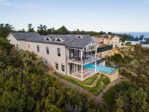 an aerial view of a house with a swimming pool at Pezula- Luxury Golf Retreat FC4 in Knysna