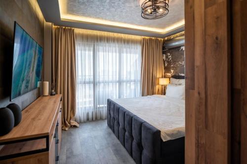 a hotel room with a bed and a large window at Apartment Deluxe Vision in Varna City