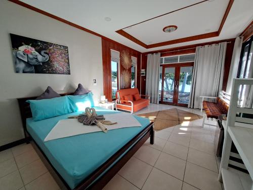a bedroom with a blue bed with a bow on it at Sense Asia in Haad Tian