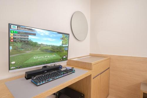 a computer monitor and keyboard on a desk at Aank Hotel Cheongju Uam 1st in Cheongju