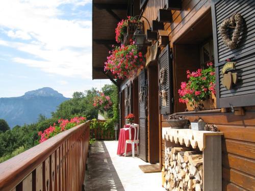 a balcony with flowers on the side of a building at Chalet la Colombière in Sainte-Agnès