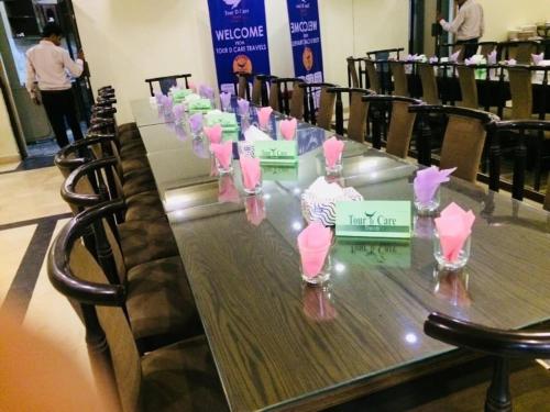 a long table with many glasses on top of it at Herfa INN Hotel Lahore in Lahore