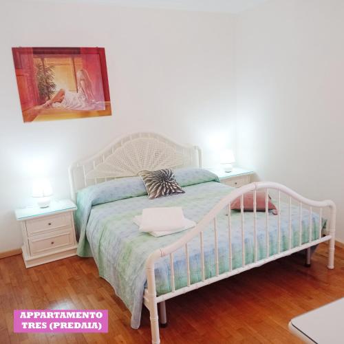 a bedroom with a bed and two night stands at APPARTAMENTO TOMA MIHAELA in Tres