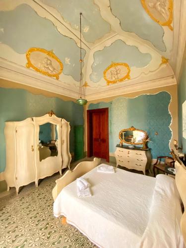 a bedroom with two beds and a ceiling with clocks at Palazzo Sabella Tommasi in Calimera
